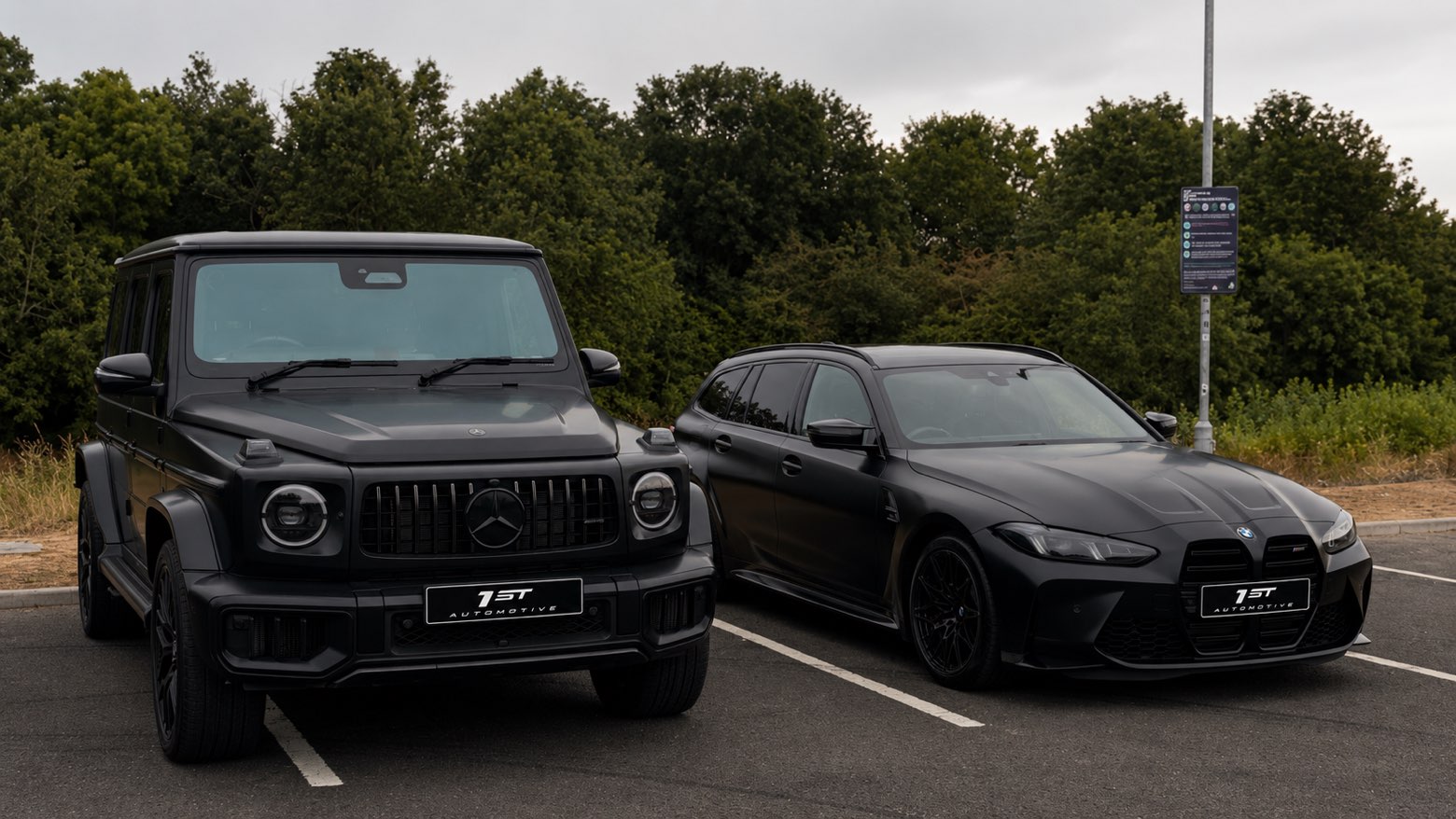 Matte black Mercedes-AMG G-Class and BMW M3 Touring parked side by side