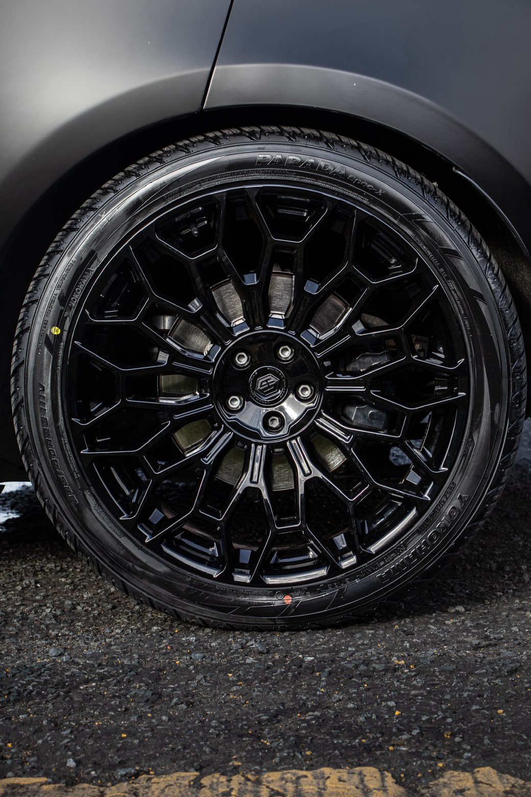 Gloss black forged wheel and Yokohama tyre, close up
